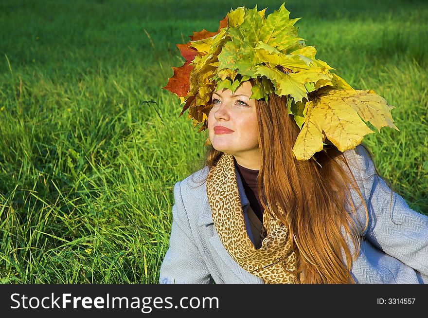 Portrait of the girl in a wreath from maple leaves