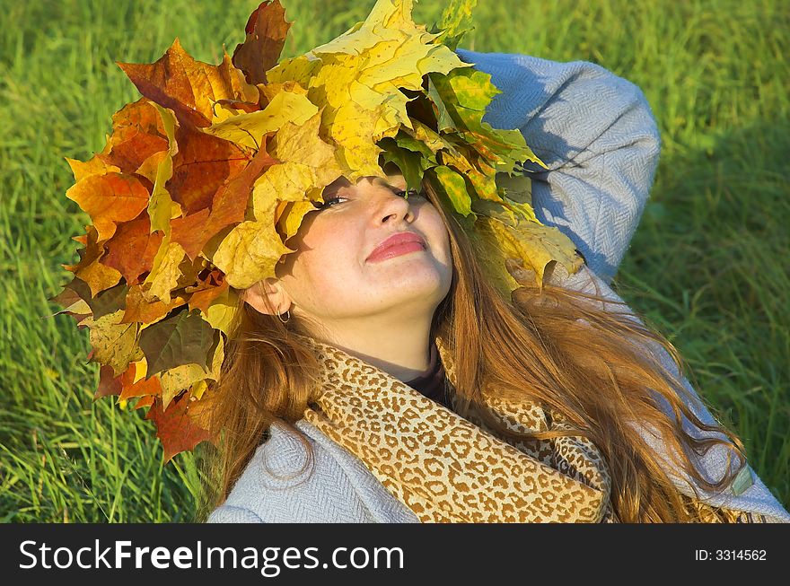 Portrait of the girl in a wreath from maple leaves