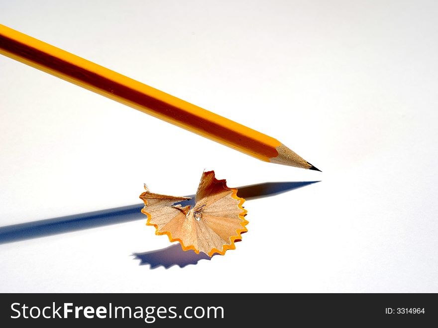 The yellow pencil on white background, the leaf of paper