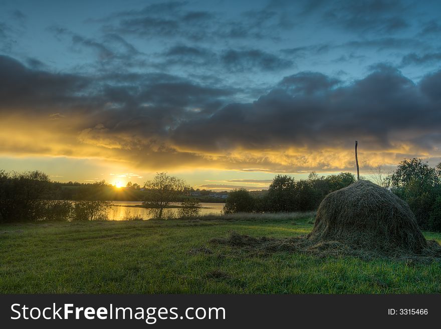 Decline on lake and a haystack on coast. Decline on lake and a haystack on coast