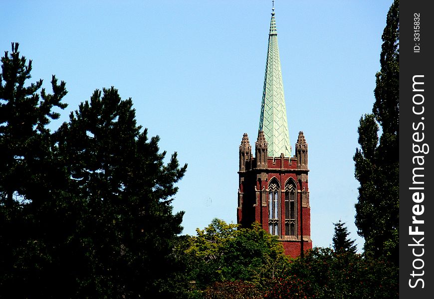 A shot of a church steeple in the distance,framed with trees. A shot of a church steeple in the distance,framed with trees.