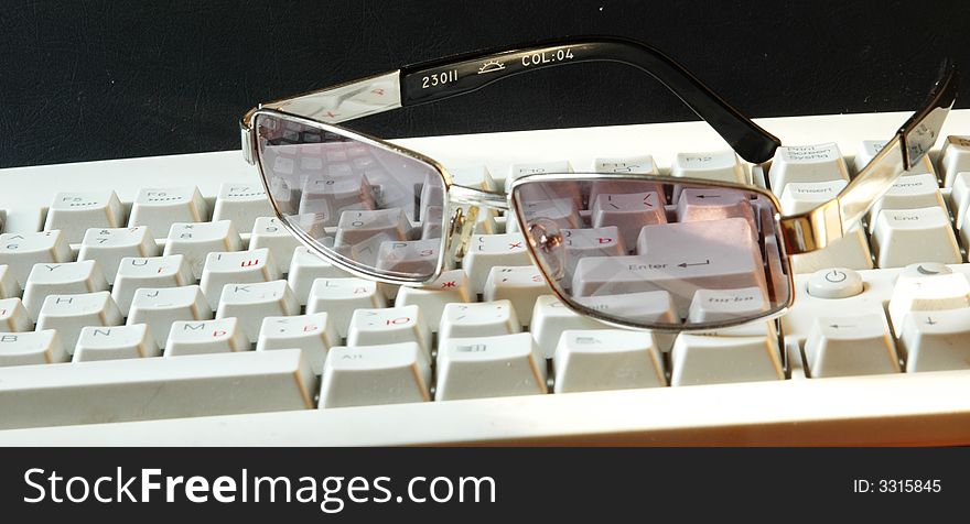 Protective glasses lyings on a keyboard. Protective glasses lyings on a keyboard