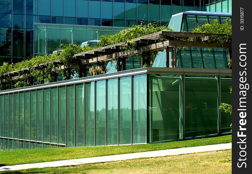 A shot of a glass building at the corner. A shot of a glass building at the corner.