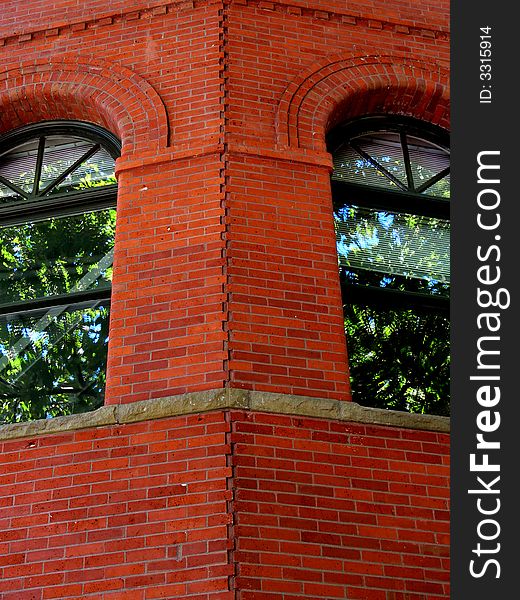 Shot of a corner of a red Brick building with windows. Shot of a corner of a red Brick building with windows.