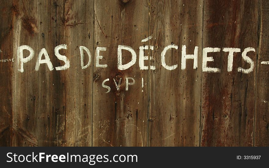 Writing on fence reading Pas De Dechets SVP!