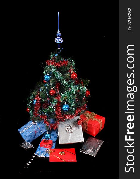 Xmas tree with presents on the black background