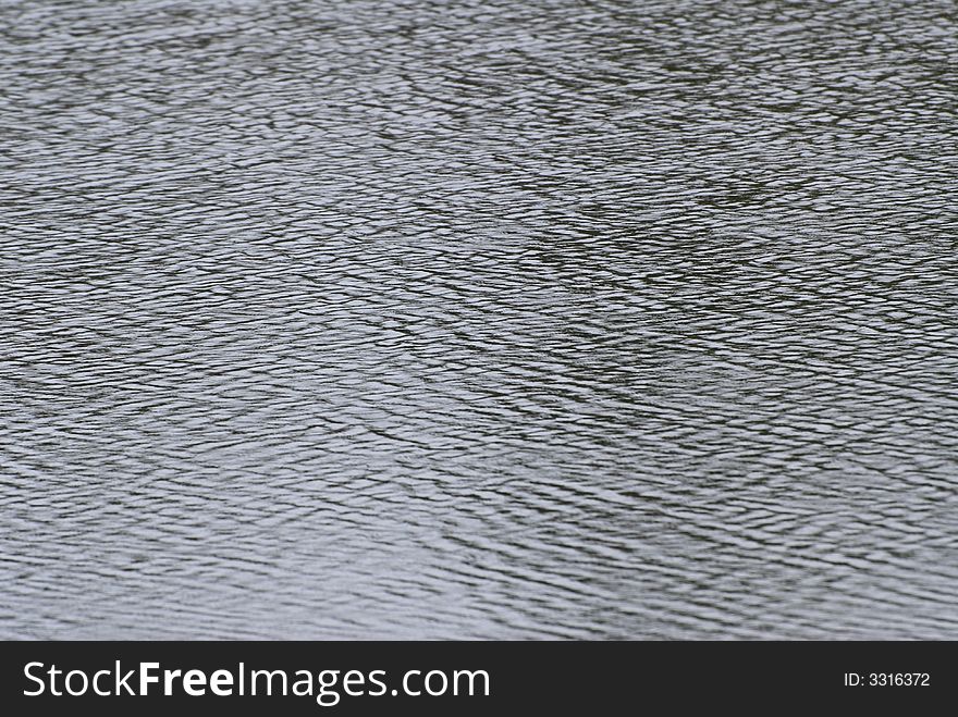 Slight ripples on a pond, creating a background abstract. Slight ripples on a pond, creating a background abstract.