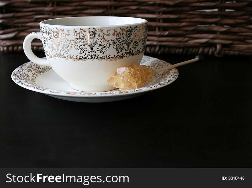 Coffee cup against a rustig background with a sugar crystal. Coffee cup against a rustig background with a sugar crystal