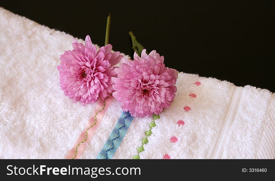 Plush pink flowers on an embroided hand towel