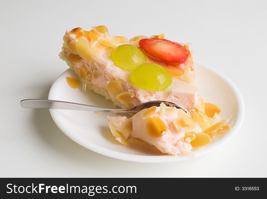 Fruit and yogurt cake with spoon nearby. Fruit and yogurt cake with spoon nearby