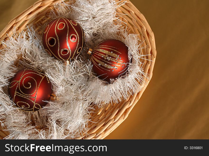 A few pieces of Chrismass decoration - three red balls in a trug with white glittering  string. A few pieces of Chrismass decoration - three red balls in a trug with white glittering  string.