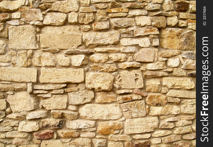 Horizontal view of a layered, sandstone exterior wall building facade. A close up of a brick wall which can be used as background. Horizontal view of a layered, sandstone exterior wall building facade. A close up of a brick wall which can be used as background
