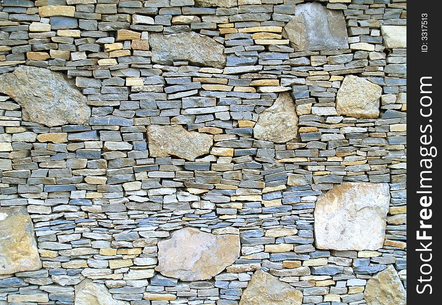 Horizontal view of a layered, sandstone exterior wall building facade. A close up of a brick wall which can be used as background. Horizontal view of a layered, sandstone exterior wall building facade. A close up of a brick wall which can be used as background.