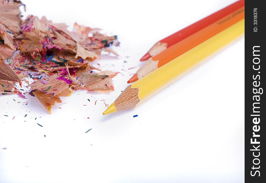 Coloured pencils and shavings on a white background