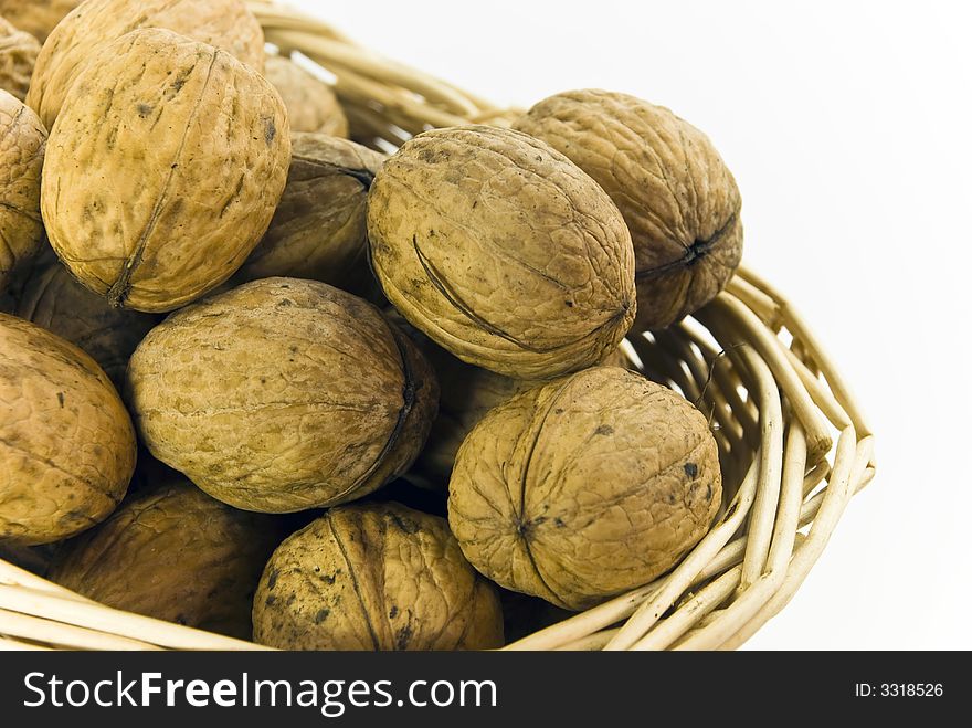 Young,fresh walnuts on the basket.