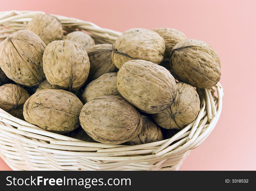Young,fresh walnuts on the basket.
