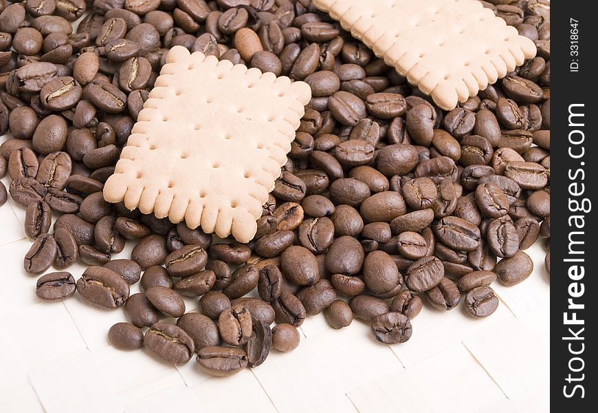 Coffee beans and biscuit on a white background