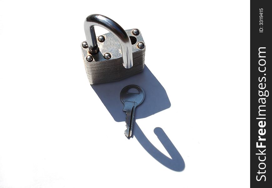 An open padlock with key, isolated on white. An open padlock with key, isolated on white.