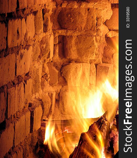 A blazing hot inferno in a crumbling fireplace. A blazing hot inferno in a crumbling fireplace