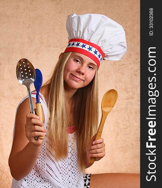 Teenage Female With Bakers Hat Cooking Utensils. Teenage Female With Bakers Hat Cooking Utensils