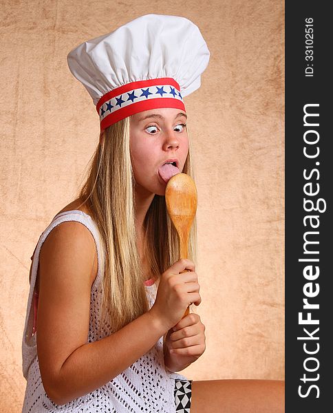 Teenage Female With Bakers Hat And Cooking Utensil. Teenage Female With Bakers Hat And Cooking Utensil