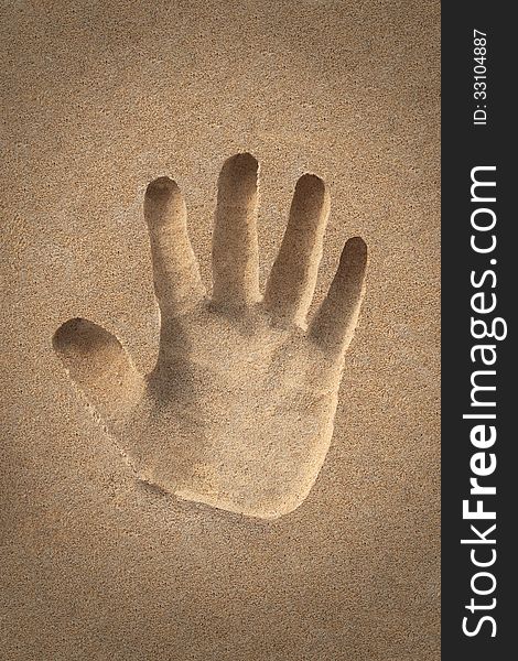Palm&#x28;hand&#x29; icon or sign creation in beach sand - concept photo