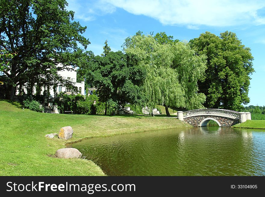 Vintage stone bridge on the lake in green park. Vintage stone bridge on the lake in green park