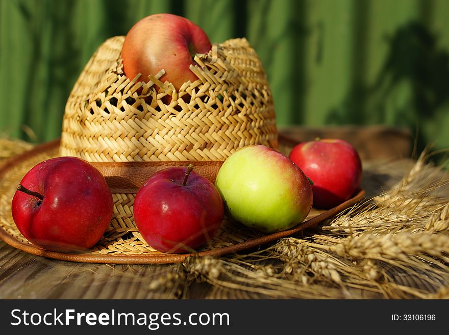 Composition With Apples, Stalks And Straw Hat.