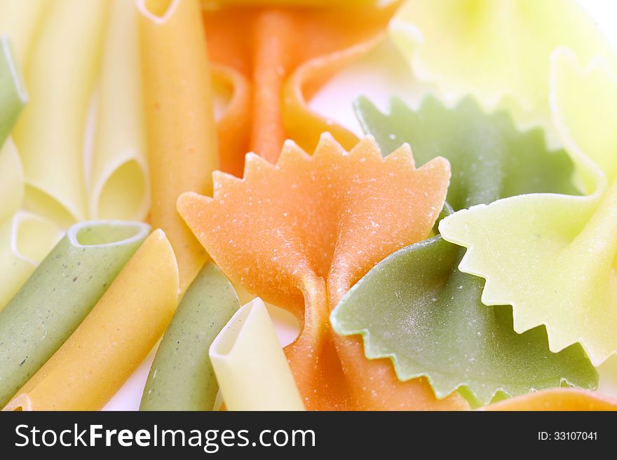 Different pasta in three colors. Macro. Background.