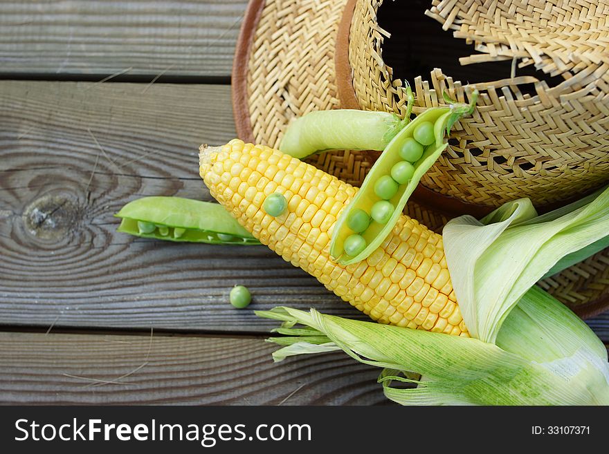 Abstract rural still life with green peas, corn, wheat and straw hat. Abstract rural still life with green peas, corn, wheat and straw hat