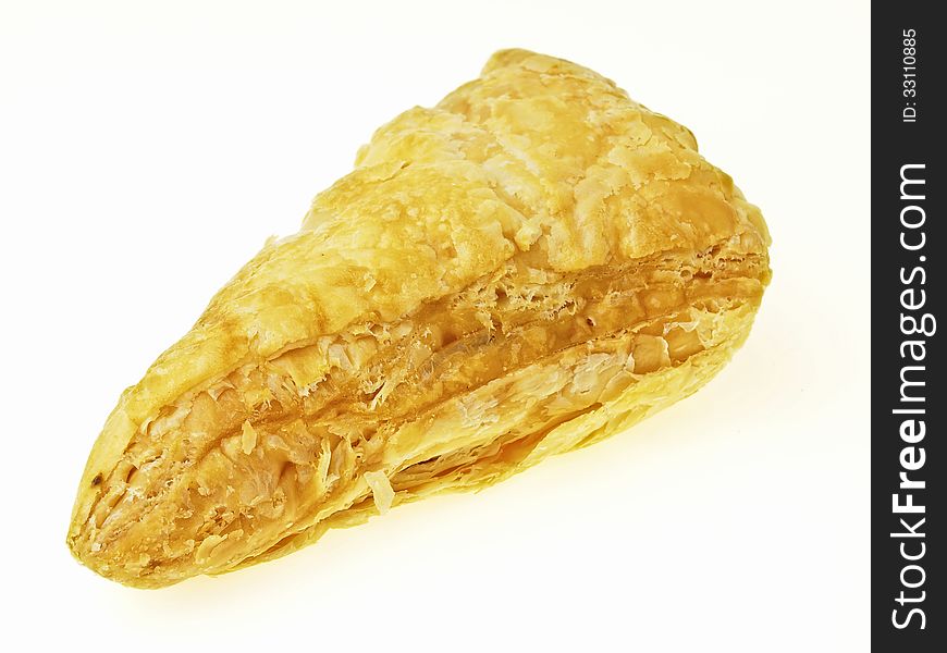 Piece of delicious puff on white background