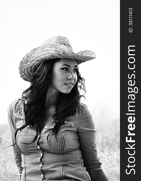 Attractive young woman wearing a cowboy hat. Attractive young woman wearing a cowboy hat.