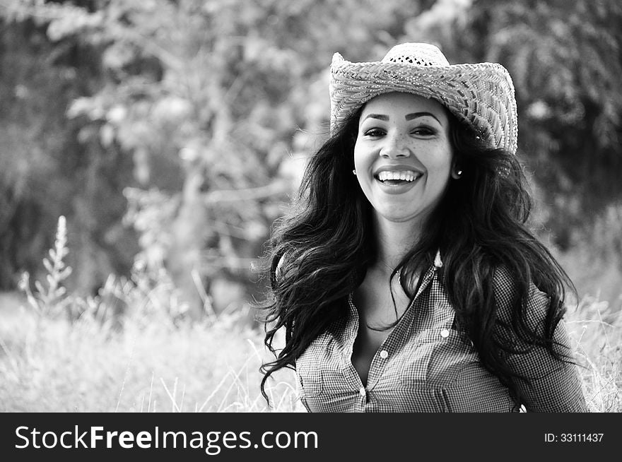 Attractive young woman wearing a cowboy hat. Attractive young woman wearing a cowboy hat.