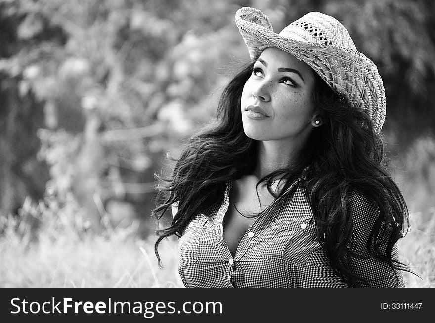 Attractive young woman wearing a cowboy hat. Attractive young woman wearing a cowboy hat.