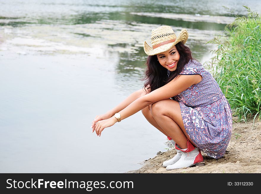 Attractive young woman wearing a cowboy hat. Attractive young woman wearing a cowboy hat.