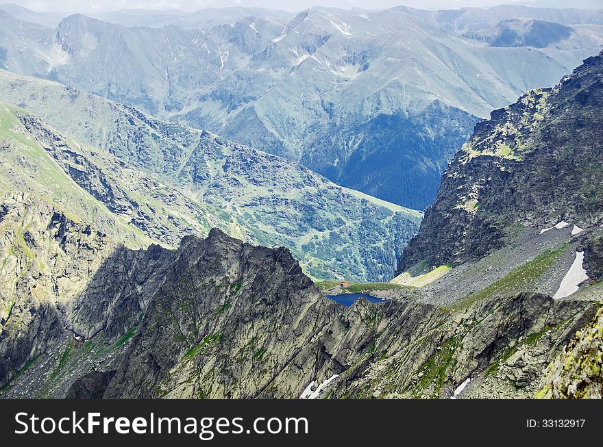 Over the clouds - view from Mount Negoiu of Caltun Lake, Fagaras Mouintains. Over the clouds - view from Mount Negoiu of Caltun Lake, Fagaras Mouintains.