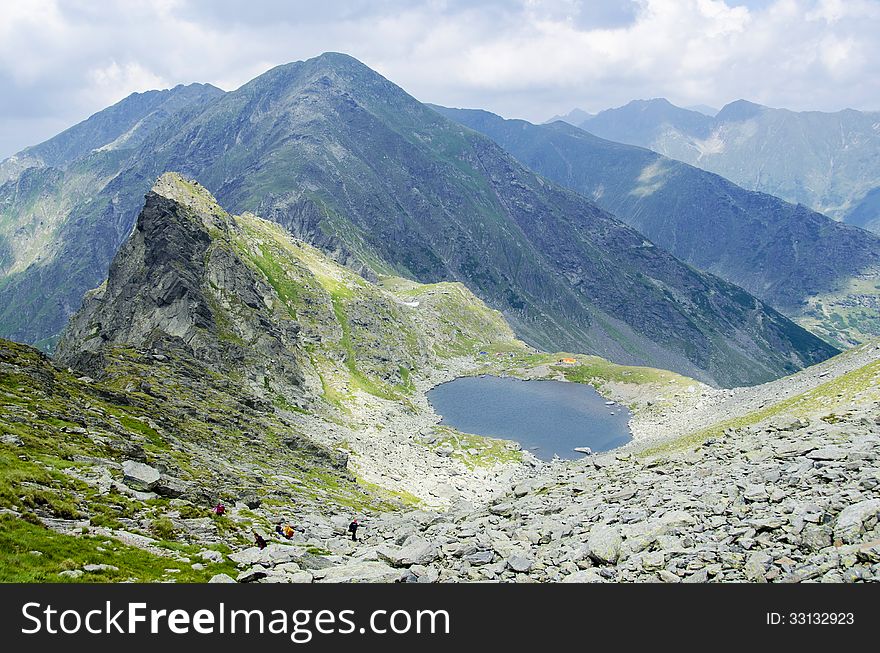 Over the clouds - view from Mount Negoiu of Caltun Lake, Fagaras Mouintains. Over the clouds - view from Mount Negoiu of Caltun Lake, Fagaras Mouintains.