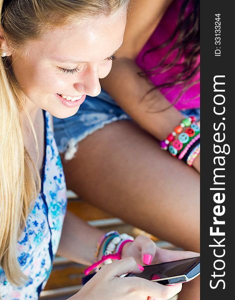 Portrait of pretty young girl chatting with smartphone