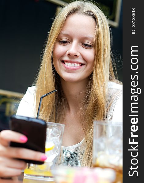 Portrait of pretty young girl chatting with smartphone