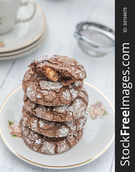 A stack of chocolate and almond cookies on a plate