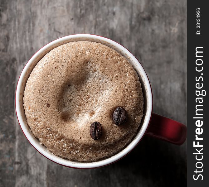 Cup of espresso with coffee beans, close up