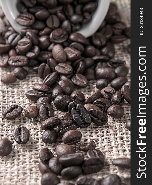 Coffee beans on canvas, close up photo