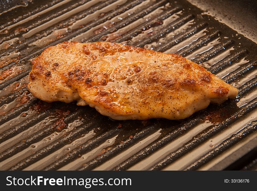 Grill chicken fillet in oil and with spices. Grill chicken fillet in oil and with spices