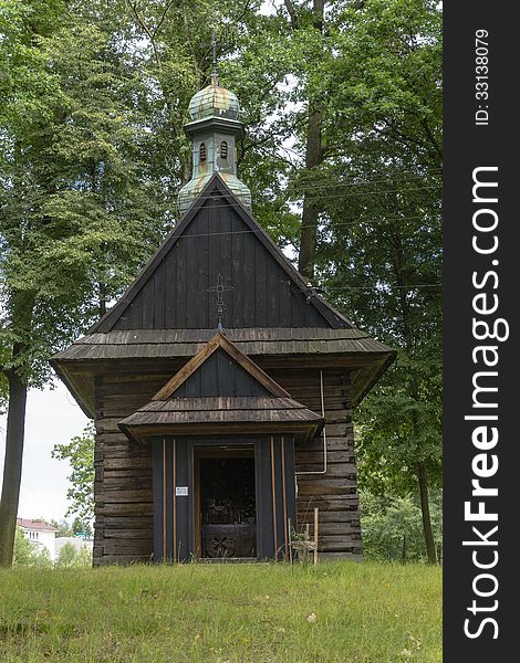 Little wooden church in forest in Siepraw near Krakow , Poland