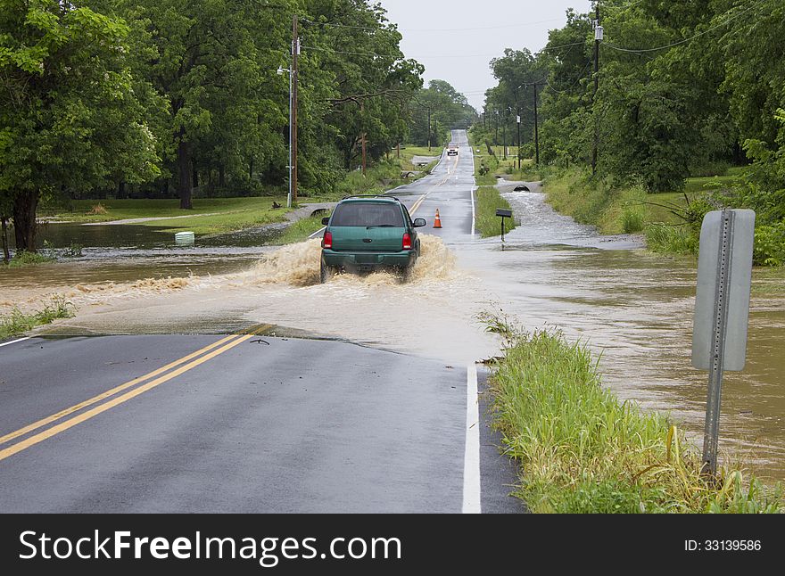 A Dodge SUV makes it safely through a flooded roadway. A Dodge SUV makes it safely through a flooded roadway.