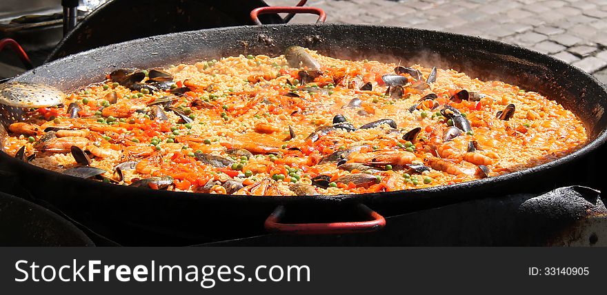 A Large Pan of Street Food Paella Being Cooked. A Large Pan of Street Food Paella Being Cooked.