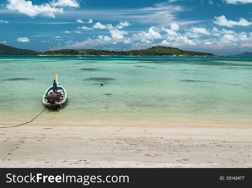 Fishing boat on the sea with cloudy blue sky