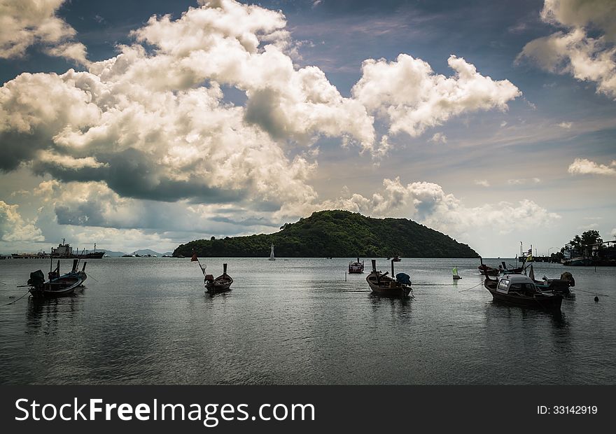 Many fishing boat on the sea with cloudy sky in the morning