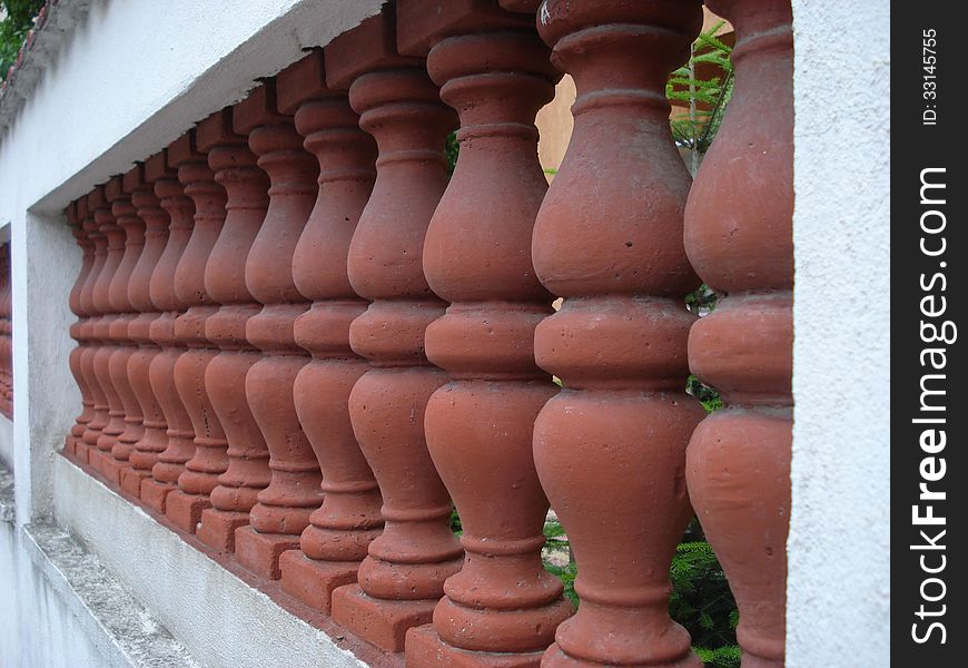 Villa fence of brick-red ceramic with white concrete frame. Villa fence of brick-red ceramic with white concrete frame