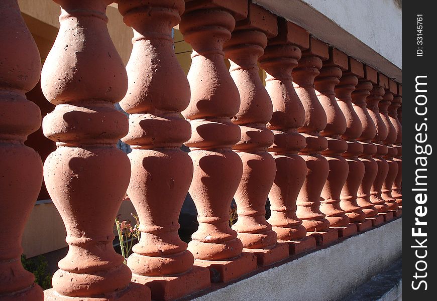 Villa fence of brick-red ceramic with white concrete frame. Villa fence of brick-red ceramic with white concrete frame